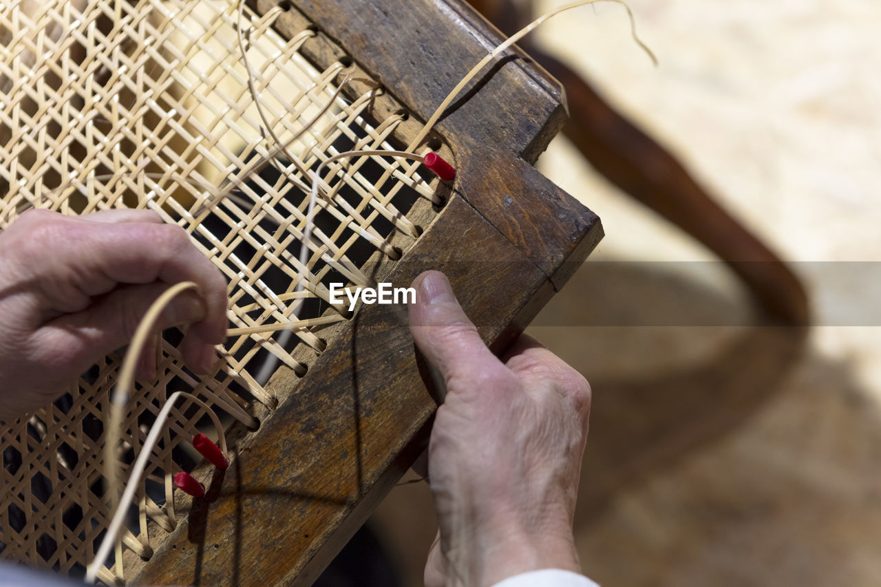 HIGH ANGLE VIEW OF MAN PLAYING PIANO ON WOOD