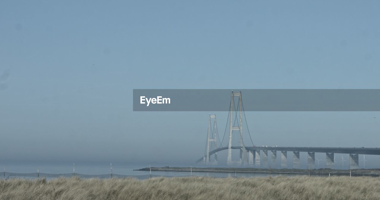 BRIDGE OVER LAND AGAINST SKY