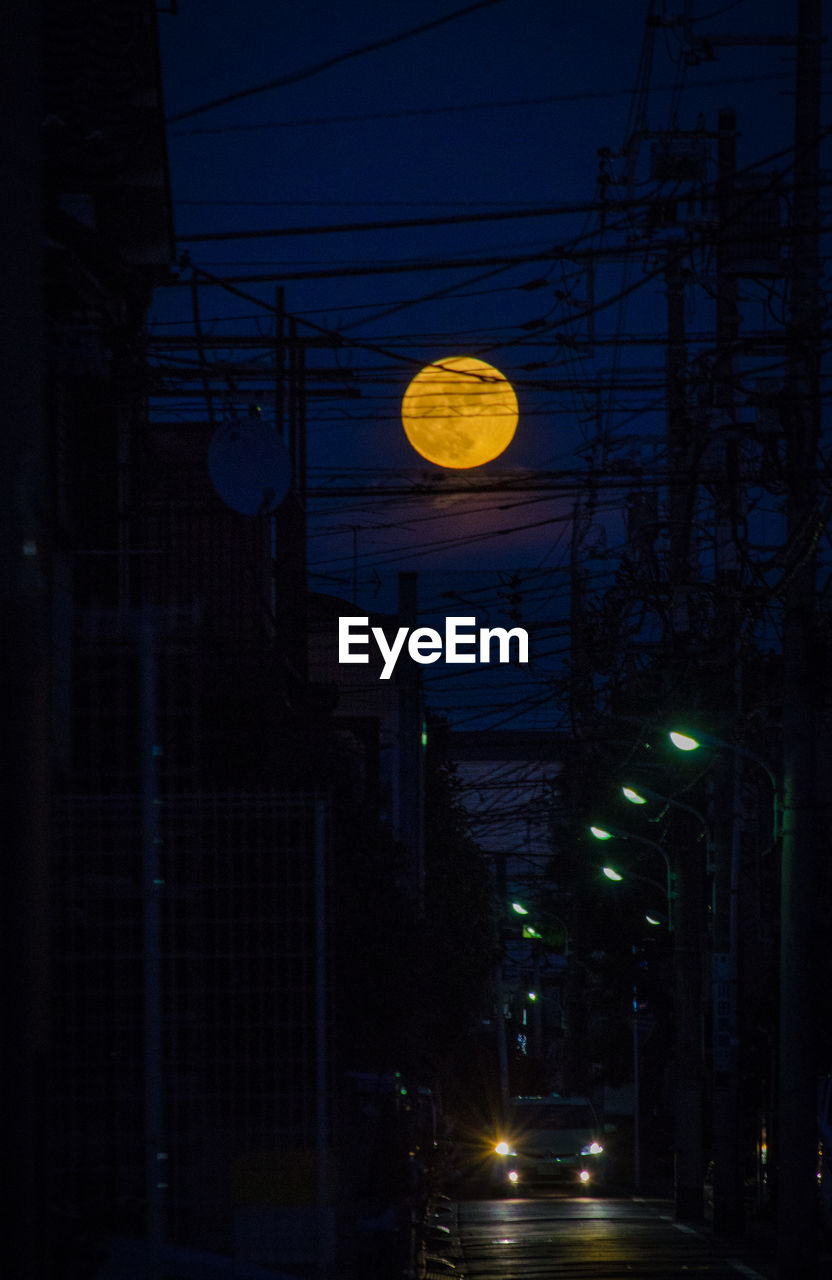 Full moon over city at night
