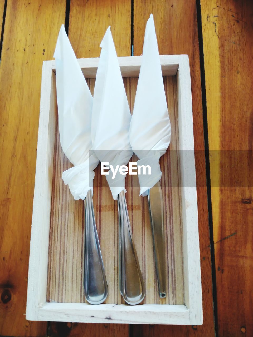 High angle view of wrapped spoon in container on table