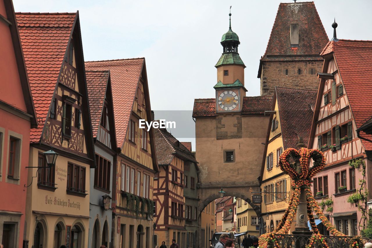 Low angle view of clock tower and buildings against sky