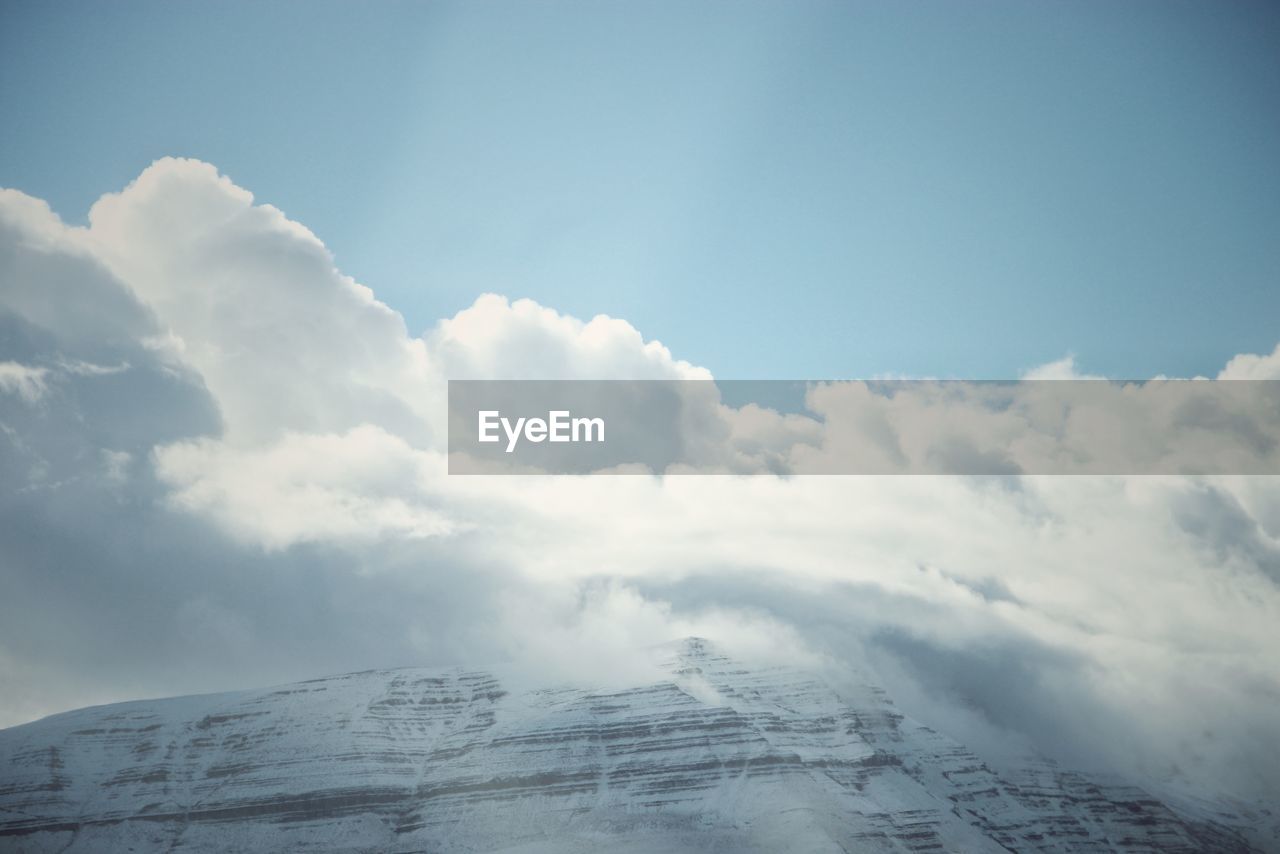 Low angle view of snowcapped mountain against sky