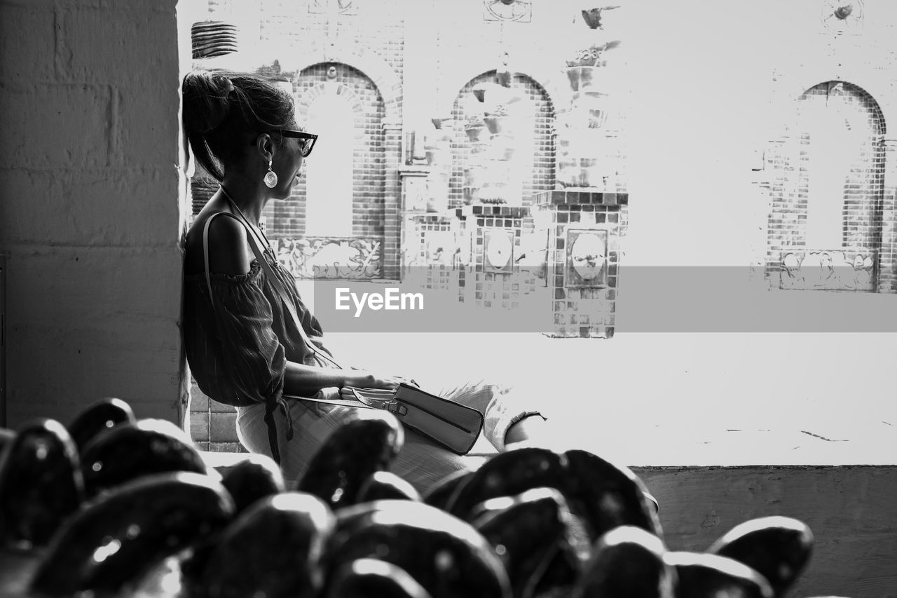 WOMAN STANDING ON WALL