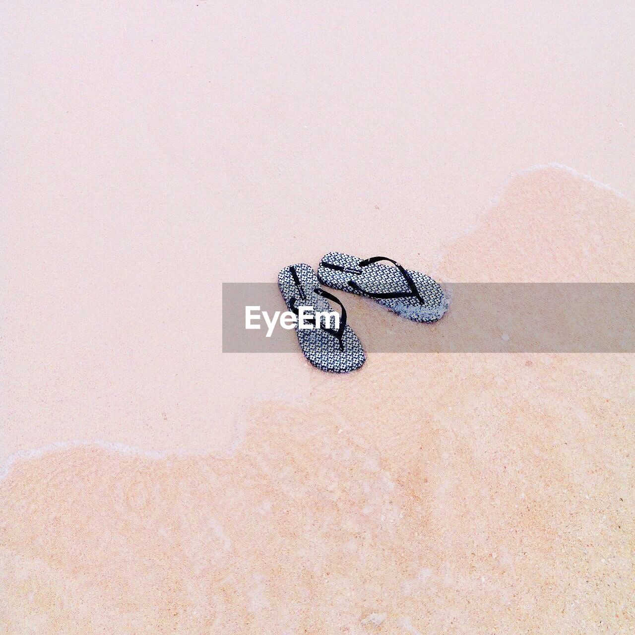 High angle view of slipper on sand
