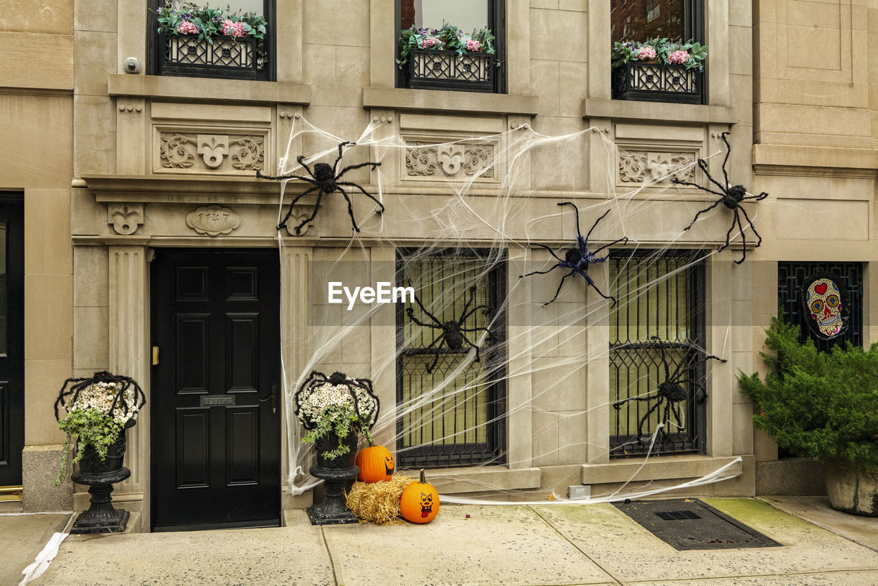 Front of apartment building decorated with spider web for halloween holiday in manhattan new york