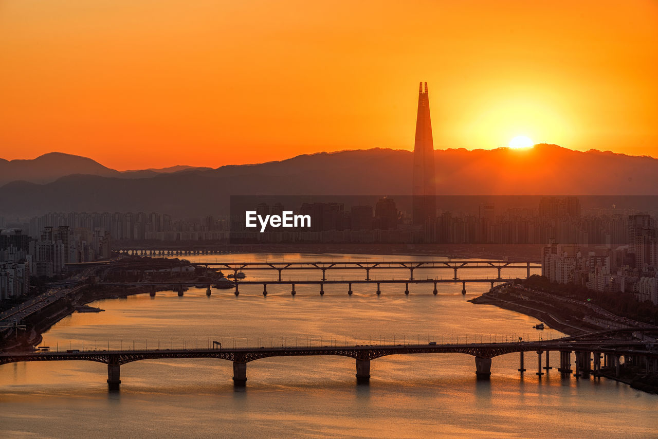 Scenic view of cityscape against sky during sunset