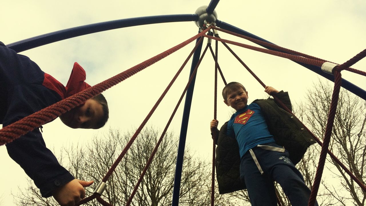 FULL LENGTH OF HAPPY GIRL PLAYING ON PLAYGROUND