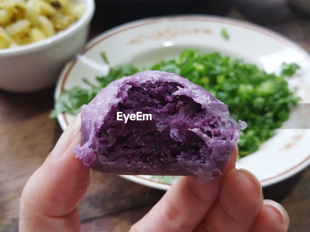 Cropped hand of person holding food