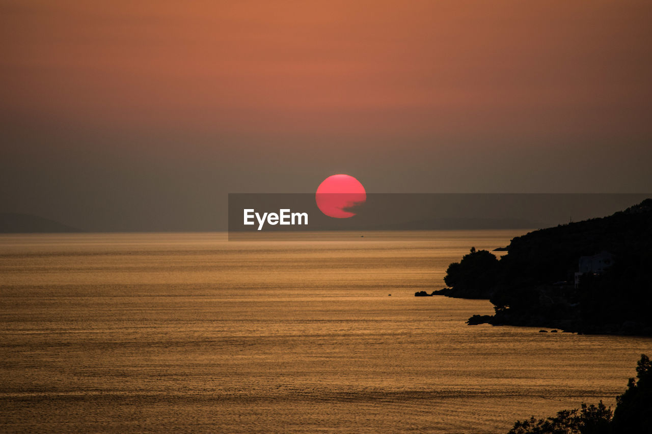 Scenic view of sea at sunset