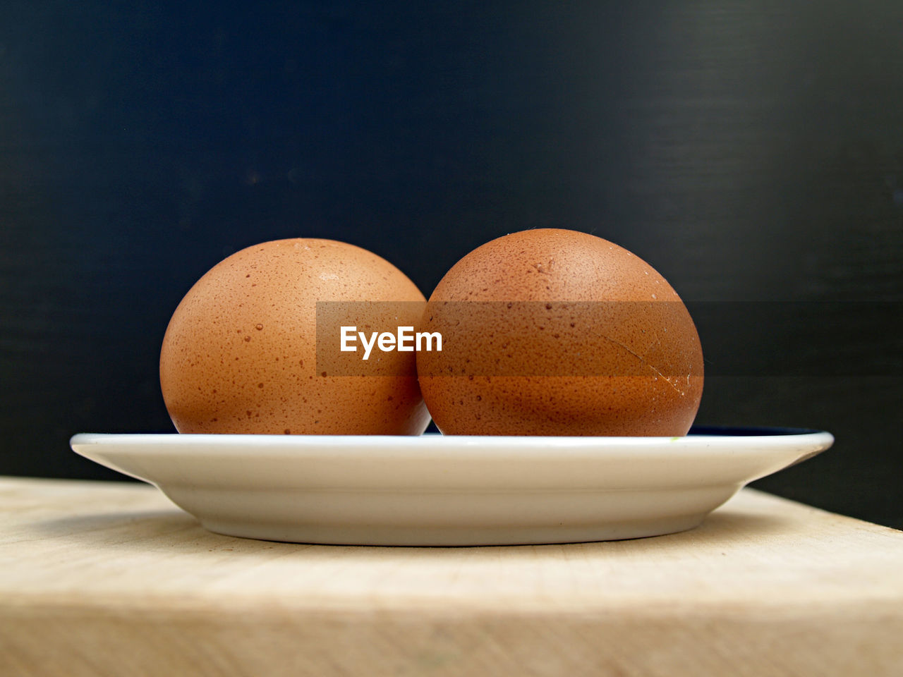 food, food and drink, egg, healthy eating, wellbeing, freshness, table, indoors, no people, still life, raw food, studio shot, bowl, animal egg, fragility, simplicity, wood, group of objects, organic, close-up, meal, brown, breakfast, ingredient, nature, shell, black background