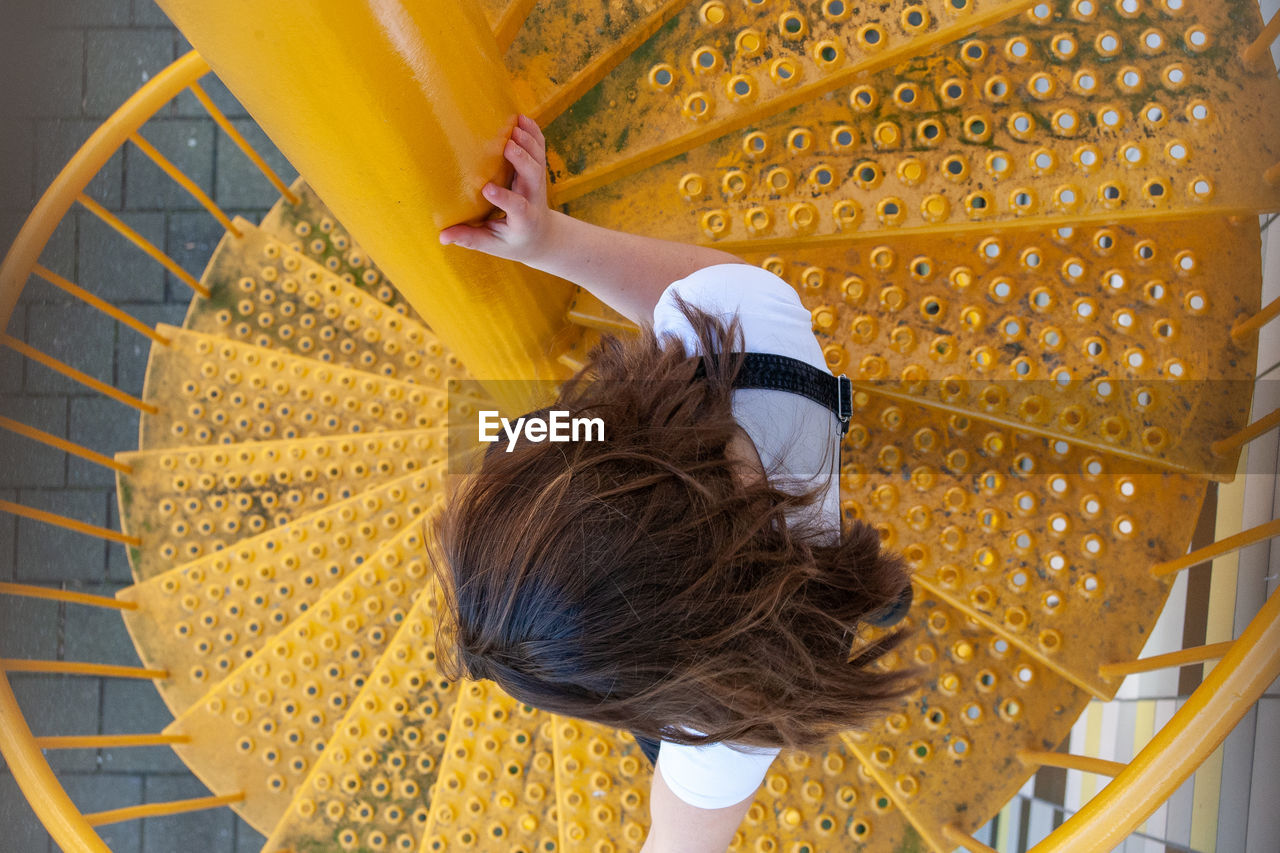 Rear view of woman walking on staircase