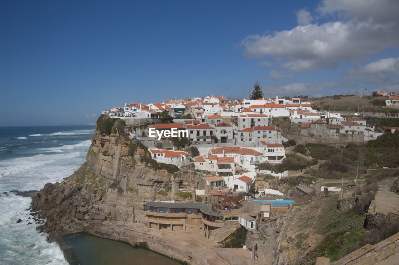 Panoramic shot of townscape by sea against sky