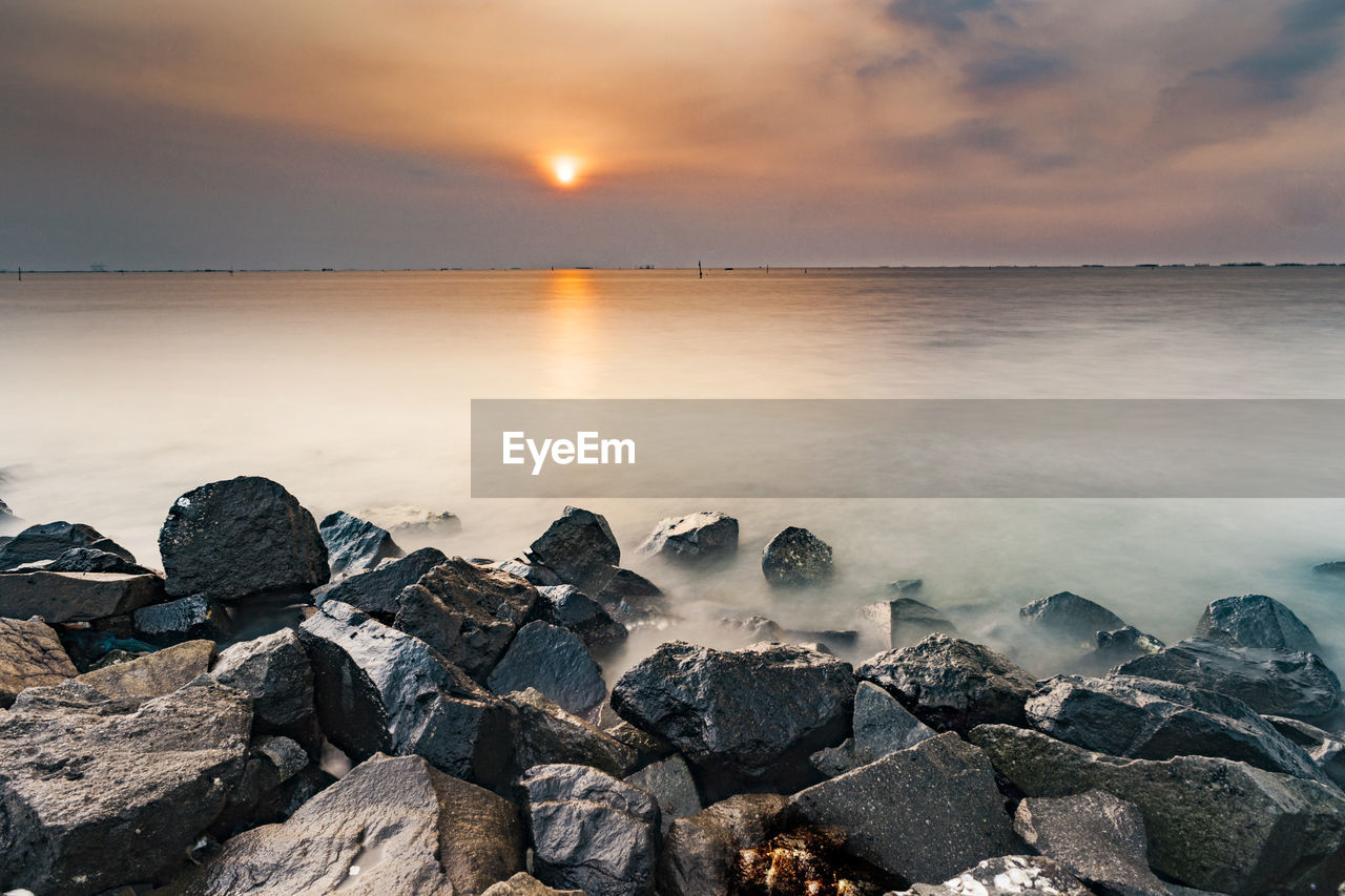 Scenic view of sea against sky during sunset