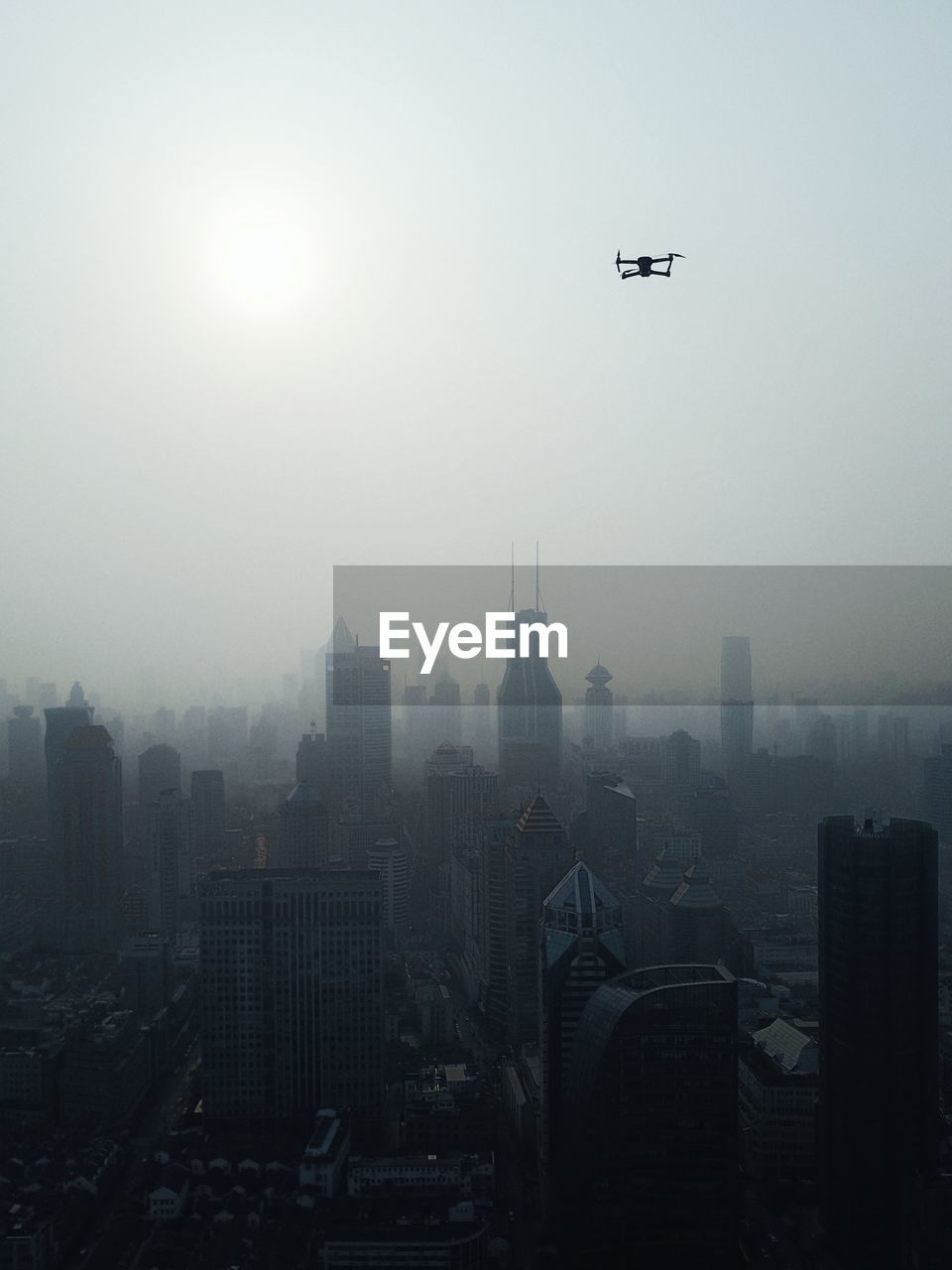 View of drone over cityscape during foggy weather