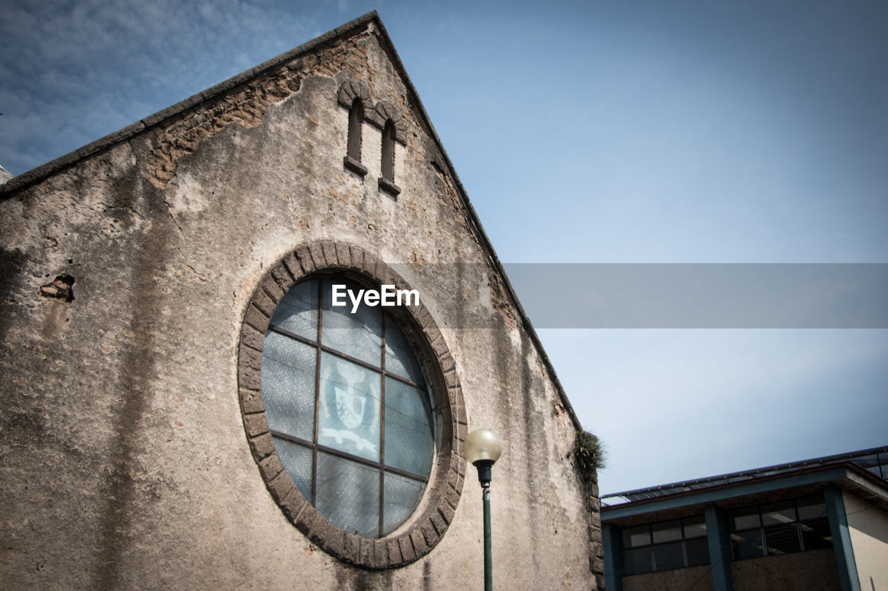 Low angle view of old building against sky