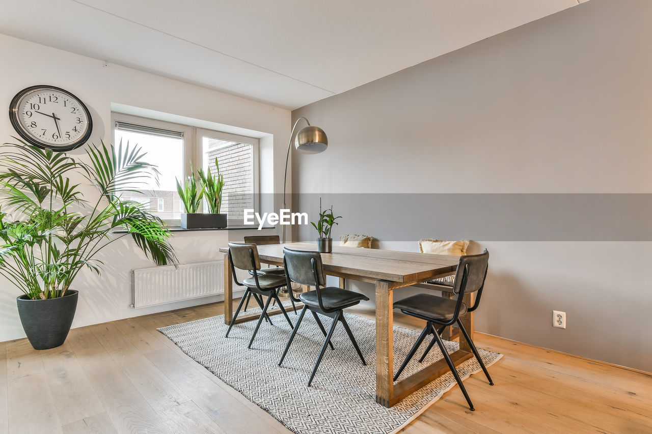 Empty chairs and table against wall at home