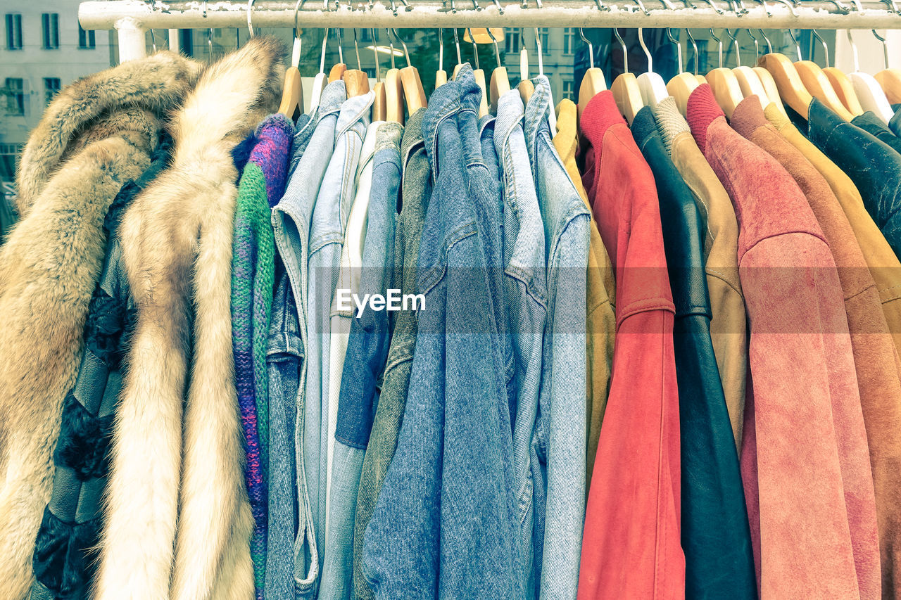 Multi colored clothes hanging on rack in store