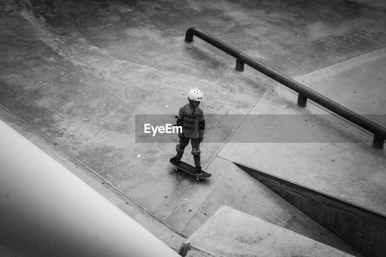 Full length of boy skateboarding at park