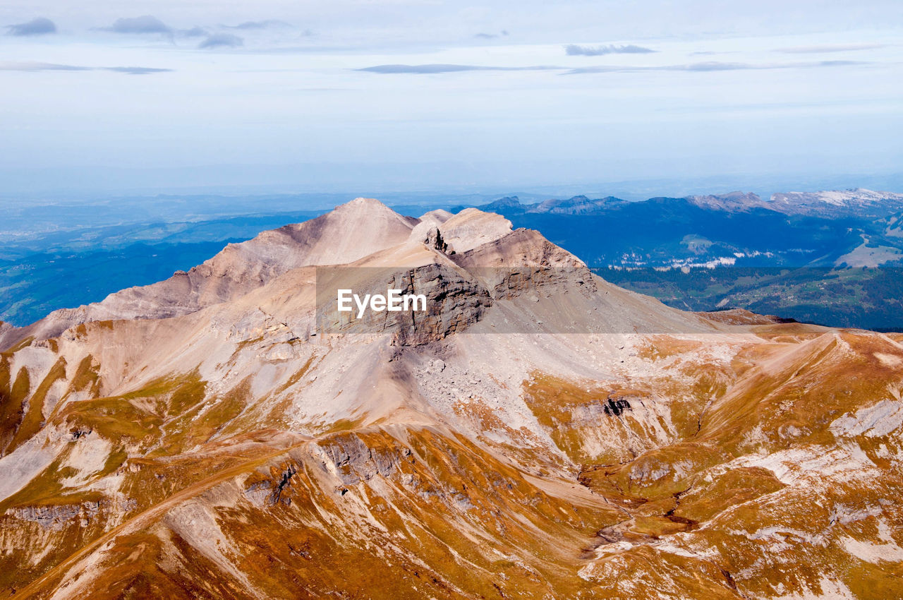 Scenic view of sea and mountains against sky