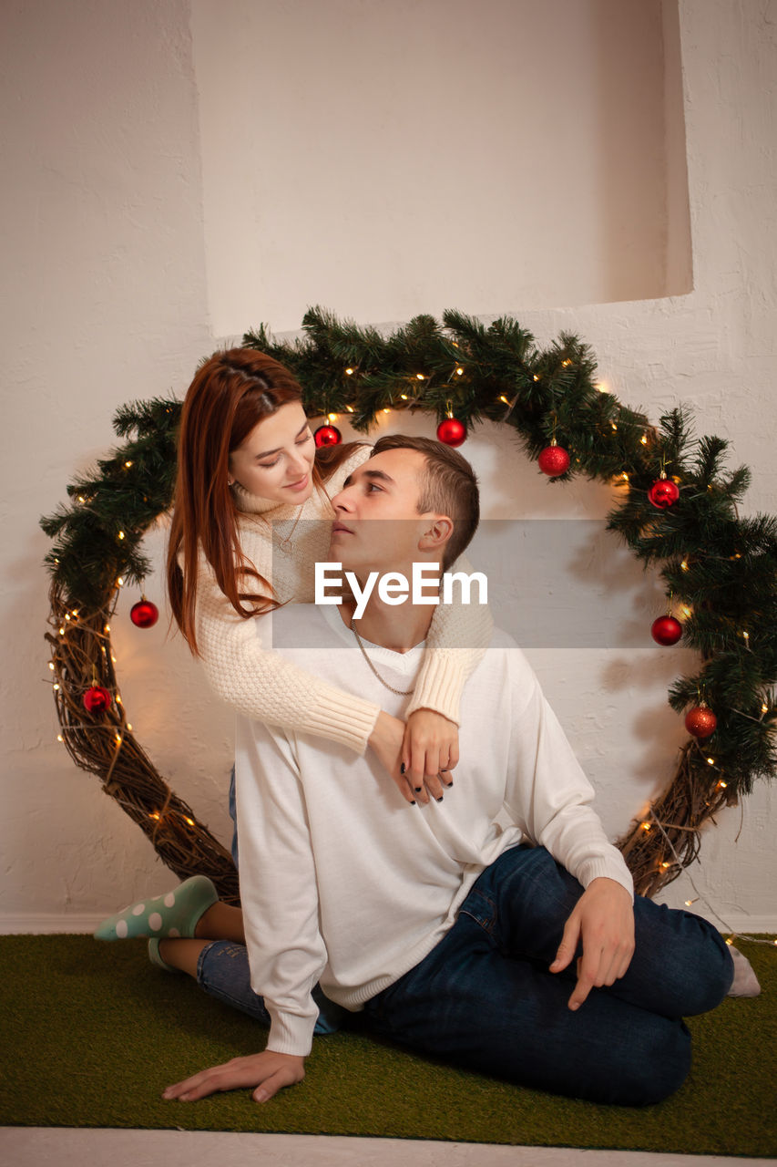 A young couple in love in a photo studio. christmas scenery, guy and girl love each other. 