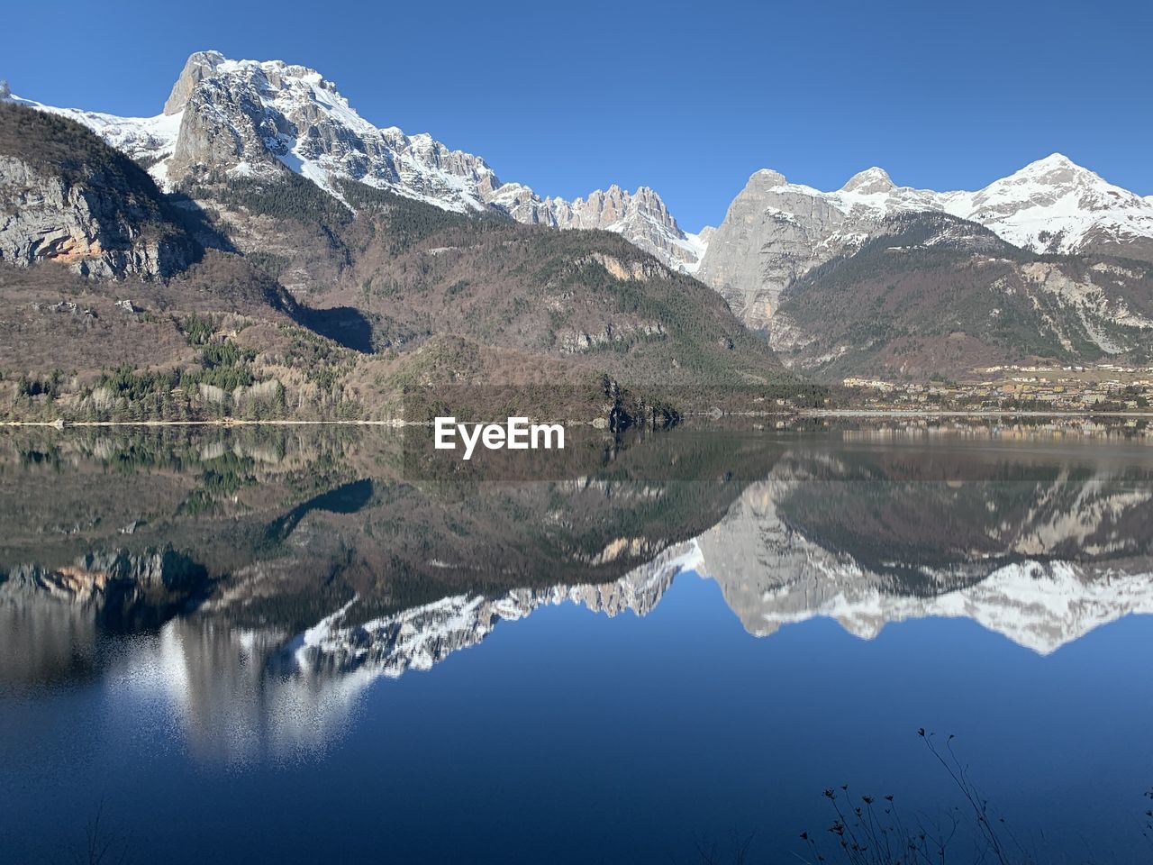 Scenic view of lake and snowcapped mountains against sky