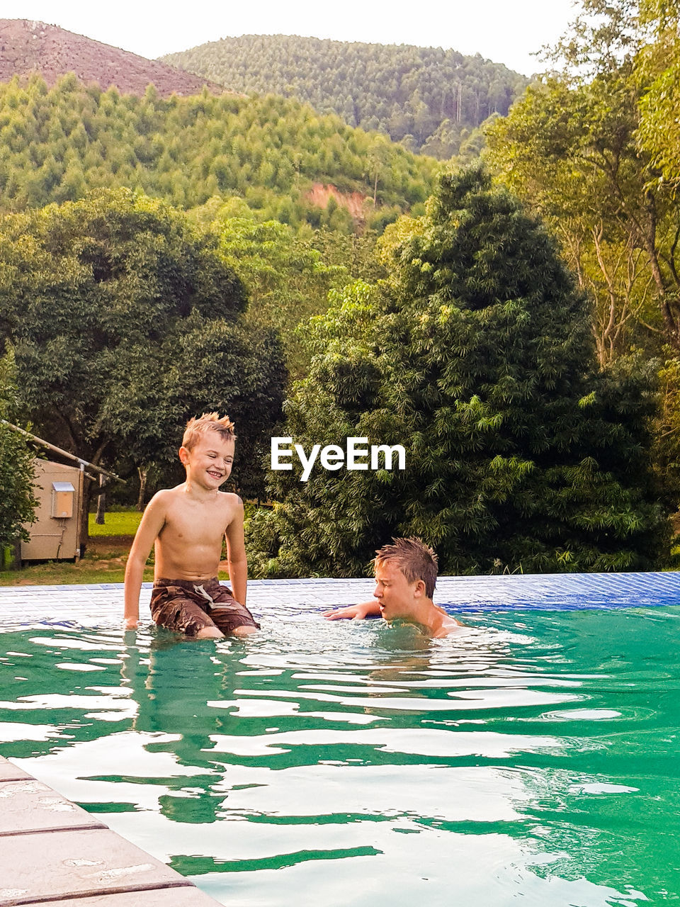 Brothers enjoying in pool