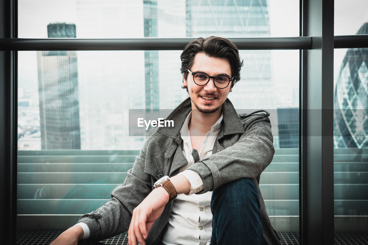 PORTRAIT OF A YOUNG MAN WITH EYEGLASSES