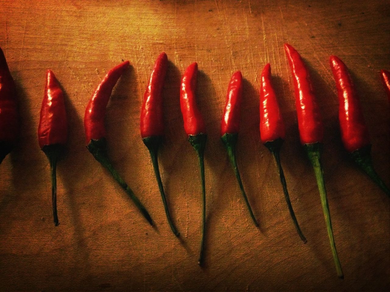 Close-up of red chilies on wooden table