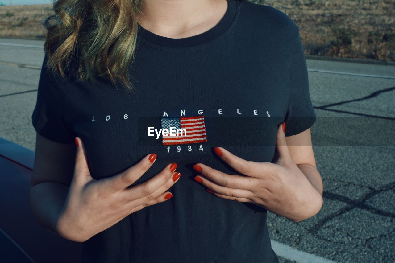 Midsection of woman wearing t-shirt with text