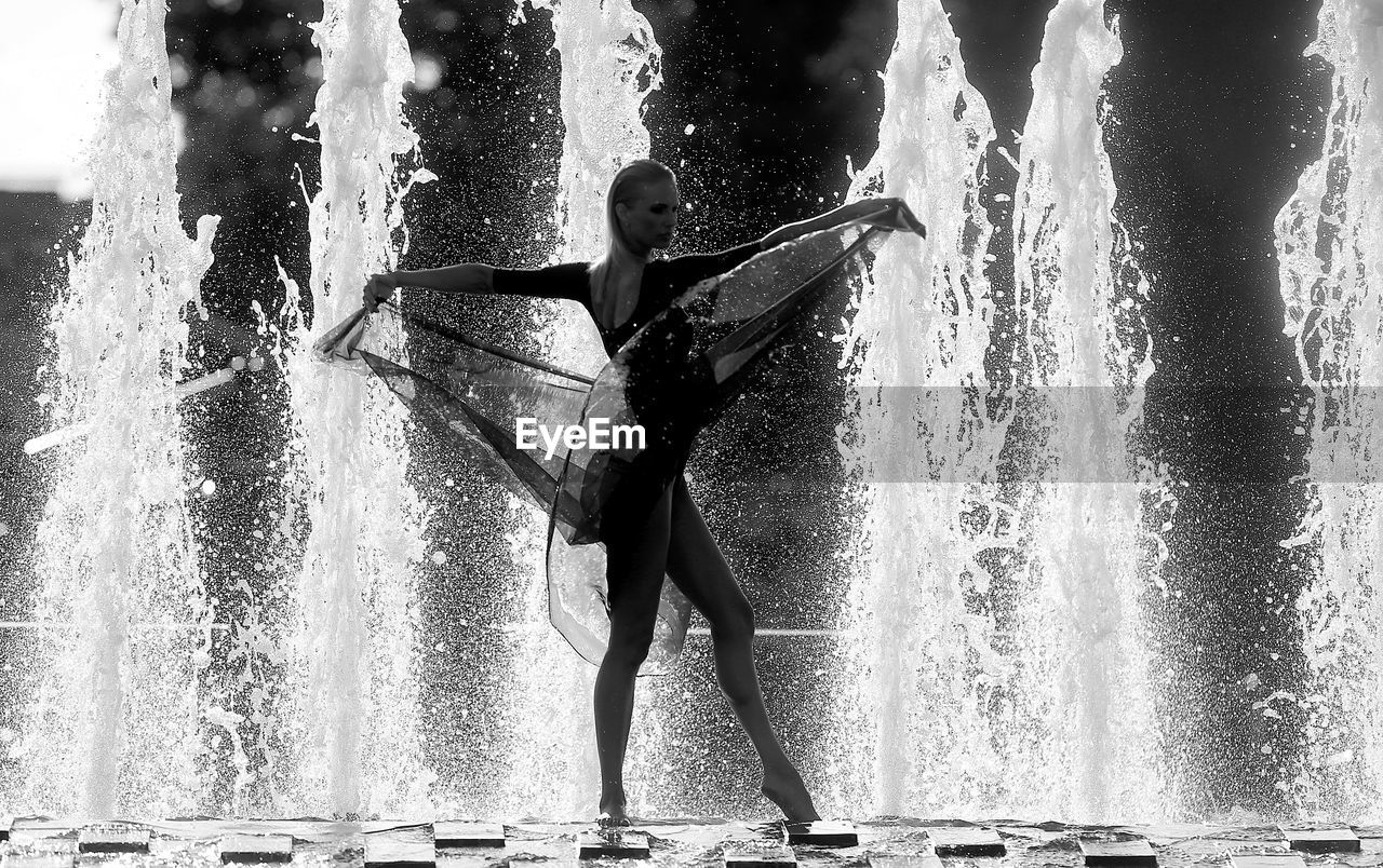 water, black and white, monochrome photography, motion, waterfall, lifestyles, monochrome, splashing, nature, day, leisure activity, one person, men, adult, fountain, outdoors, sports, women, black, enjoyment, sunlight, water sports, water feature, sea, surfing, person, swimming pool, full length