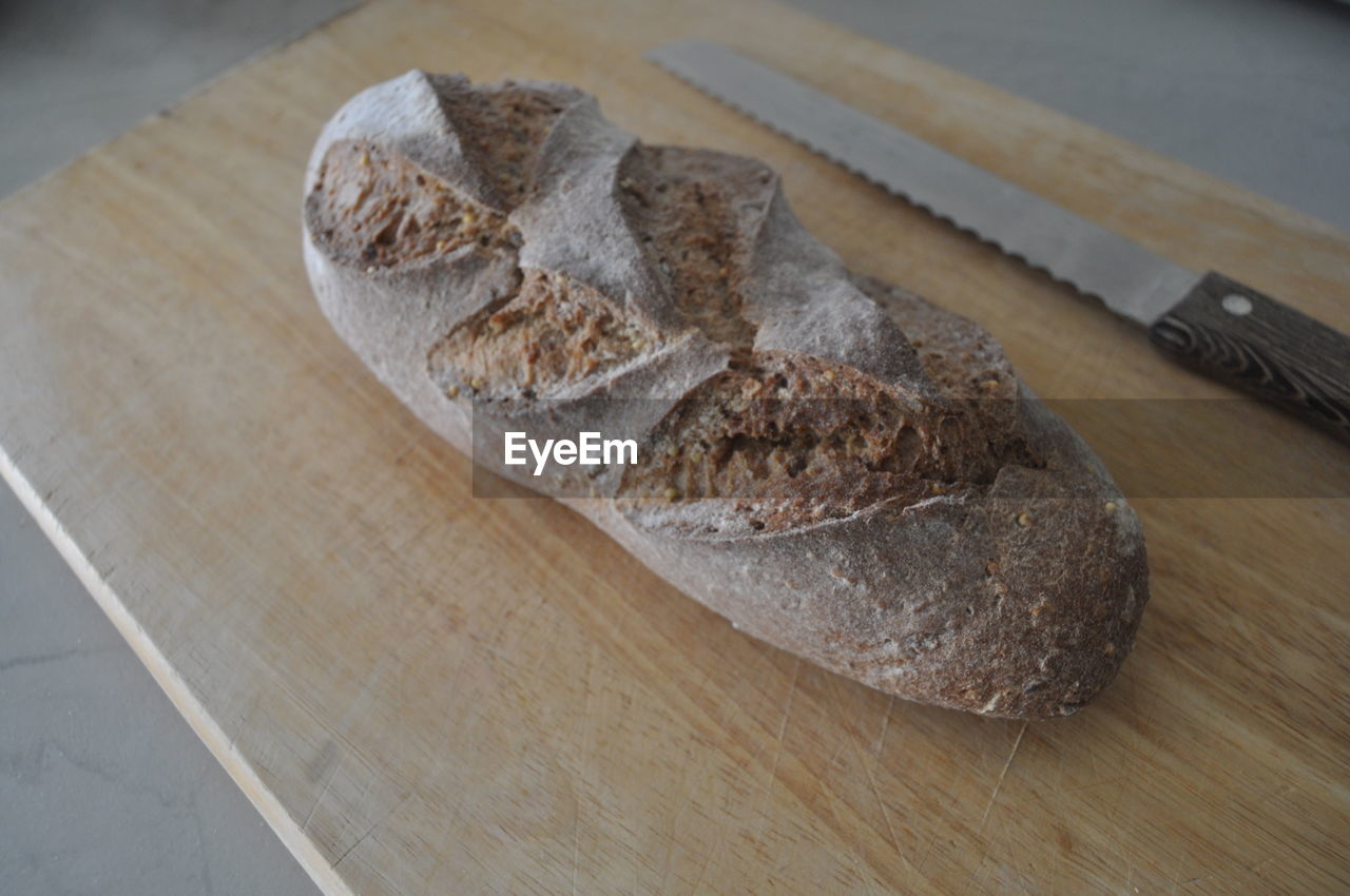 High angle view of bread and knife on cutting board