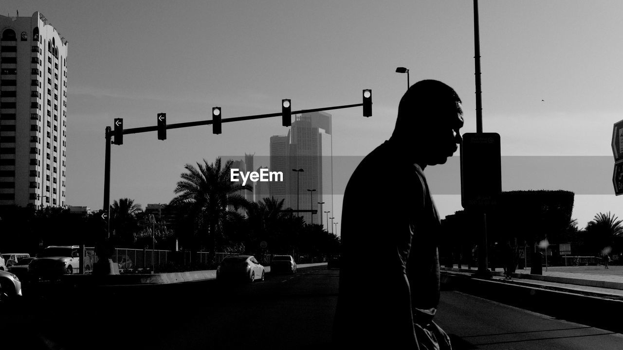 MAN STANDING AGAINST SKY