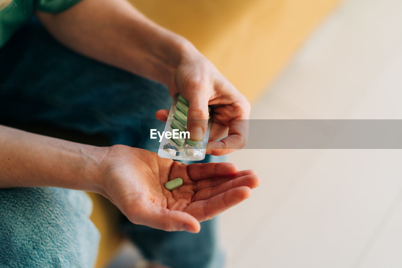 Close-up of a pack of antidepressant or painkillers pills in female hands.