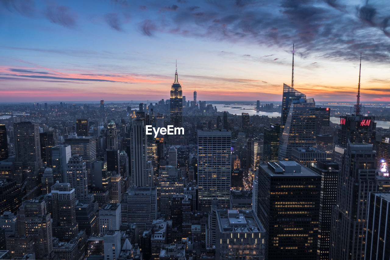 Aerial view of city lit up at sunset