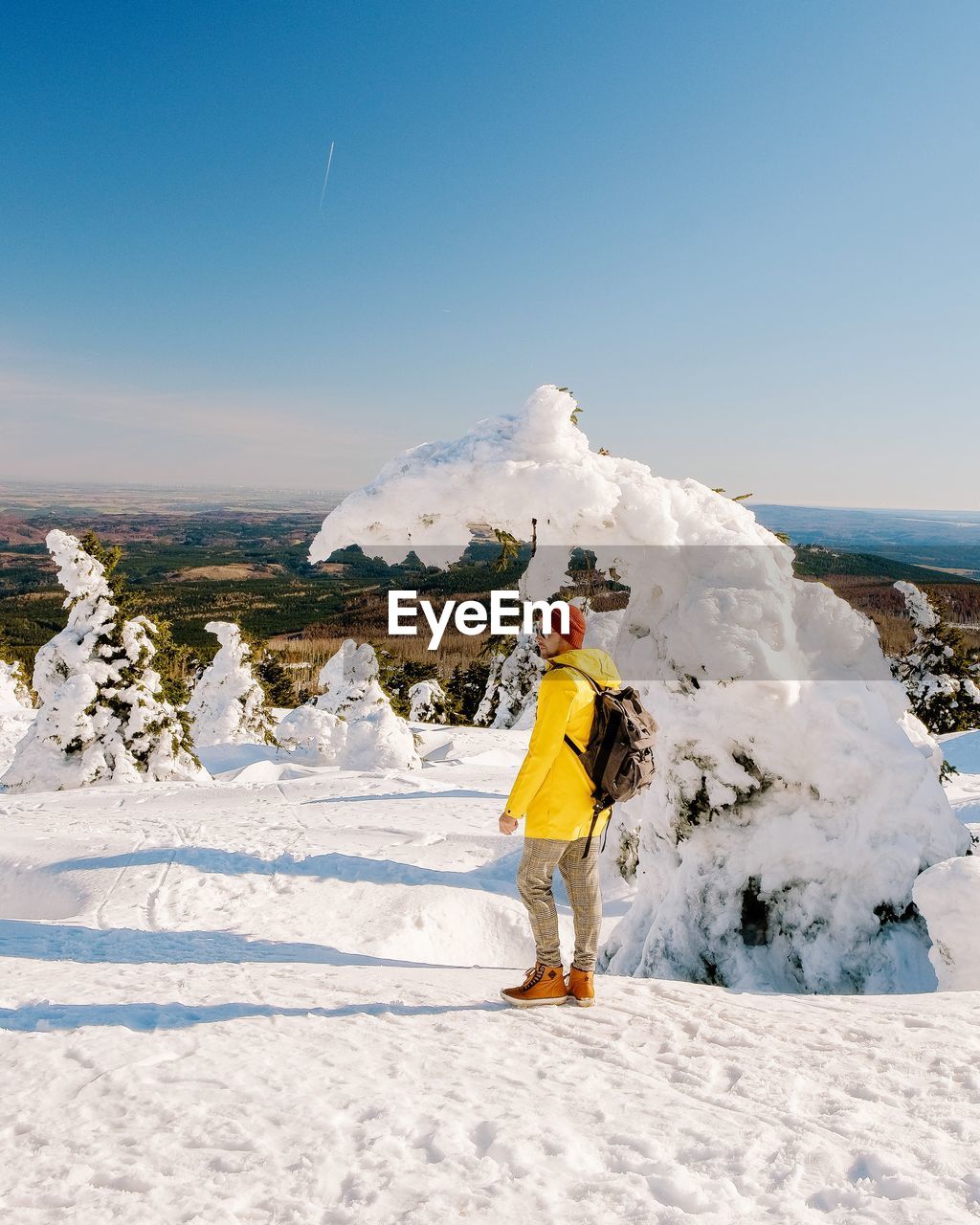 PERSON STANDING ON SNOW AGAINST SKY