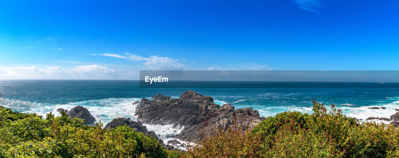 Scenic view of sea against blue sky