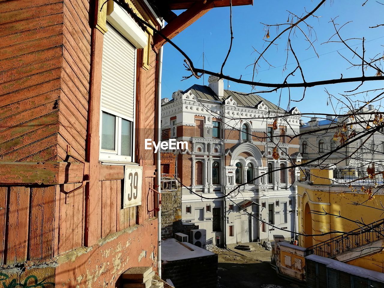 Low angle view of buildings in town against sky