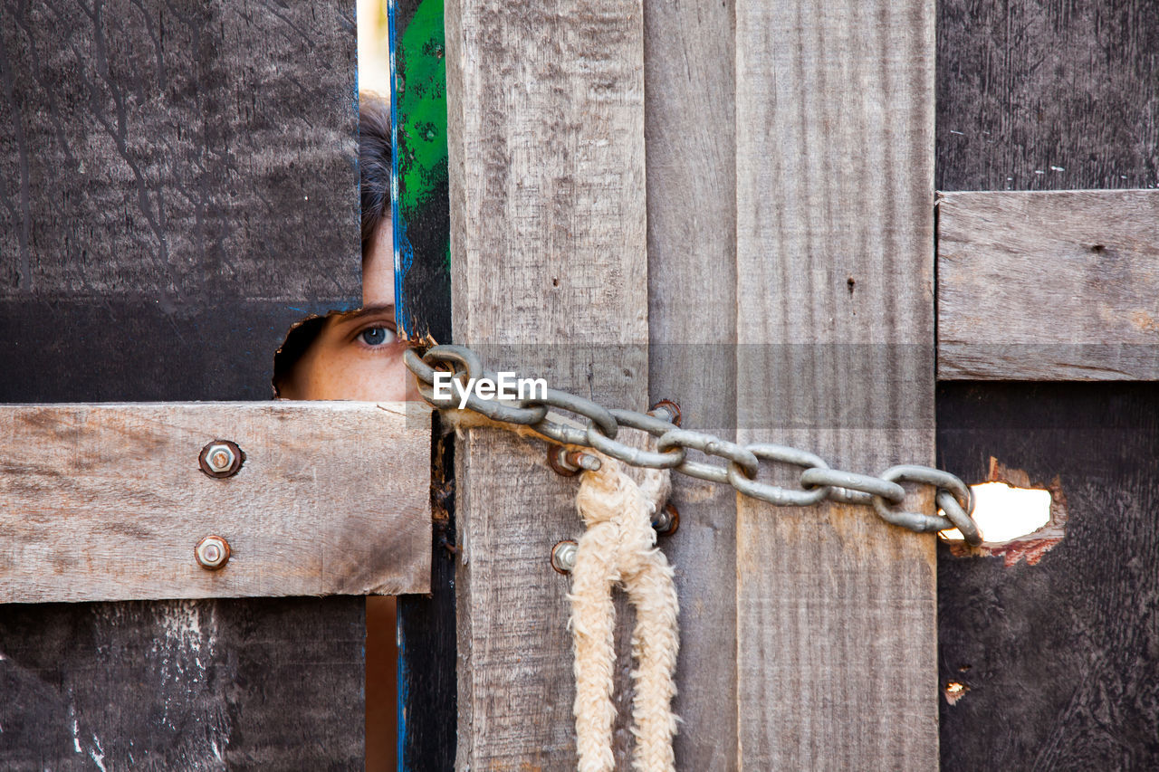 Portrait of woman peeking through door