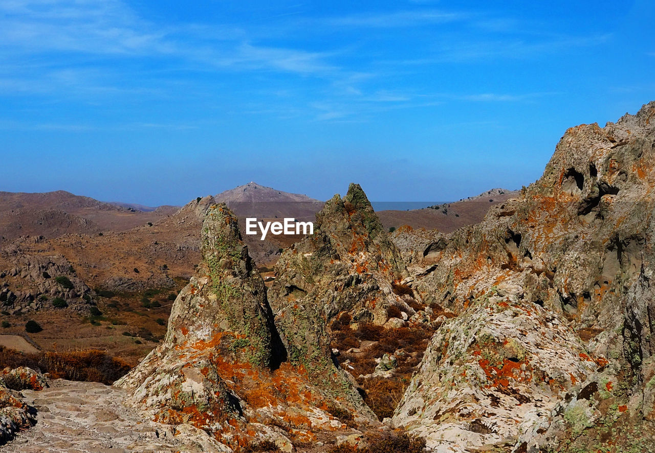ROCK FORMATION ON LANDSCAPE AGAINST SKY