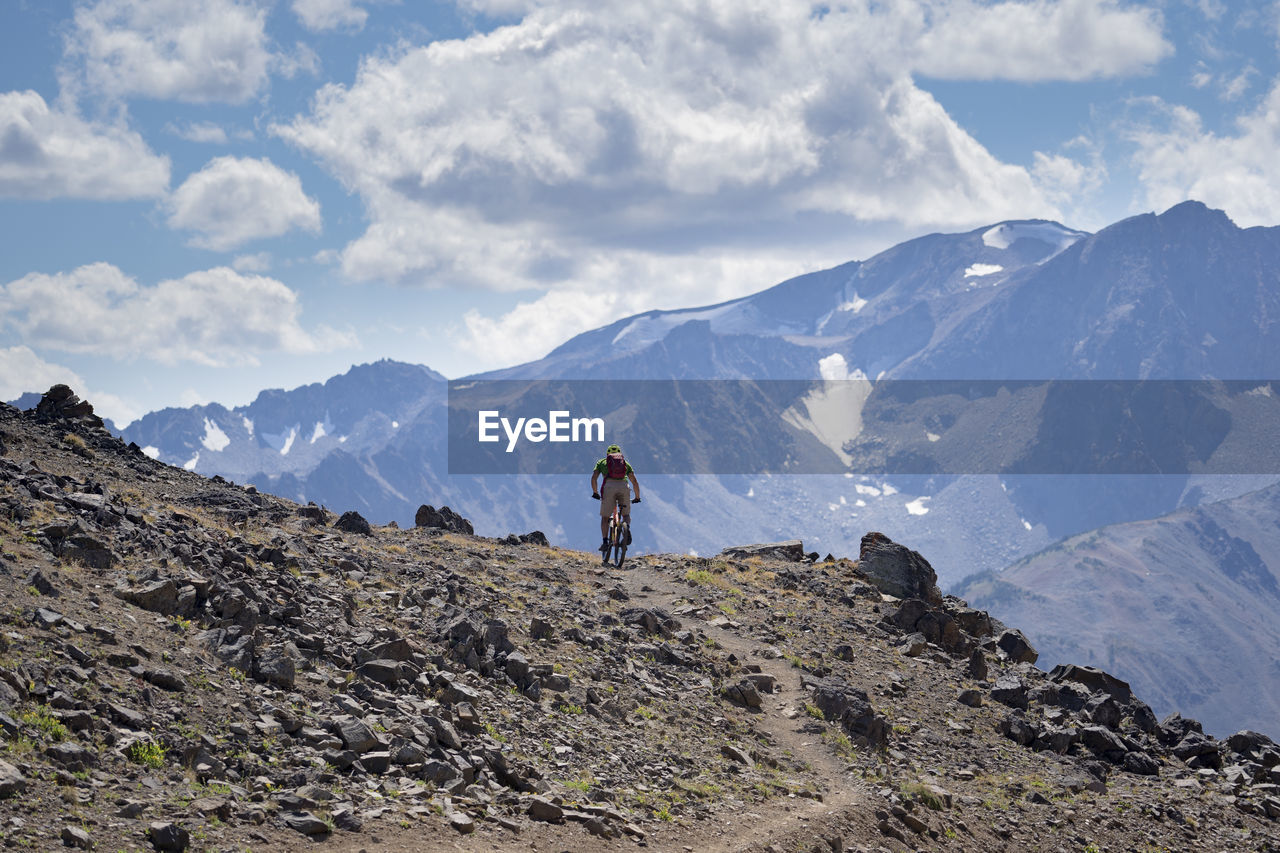 SCENIC VIEW OF MOUNTAINS AND AGAINST SKY