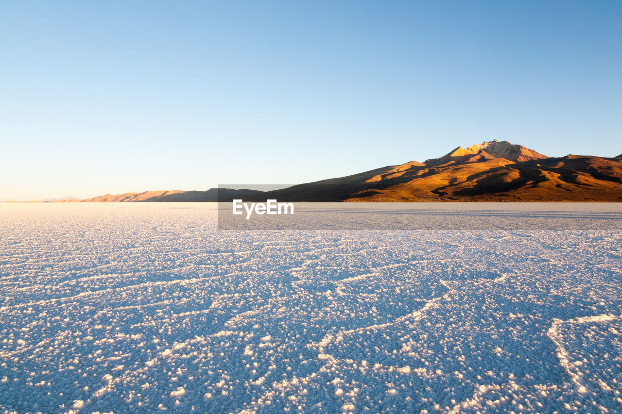 SCENIC VIEW OF SNOWCAPPED MOUNTAINS AGAINST CLEAR SKY