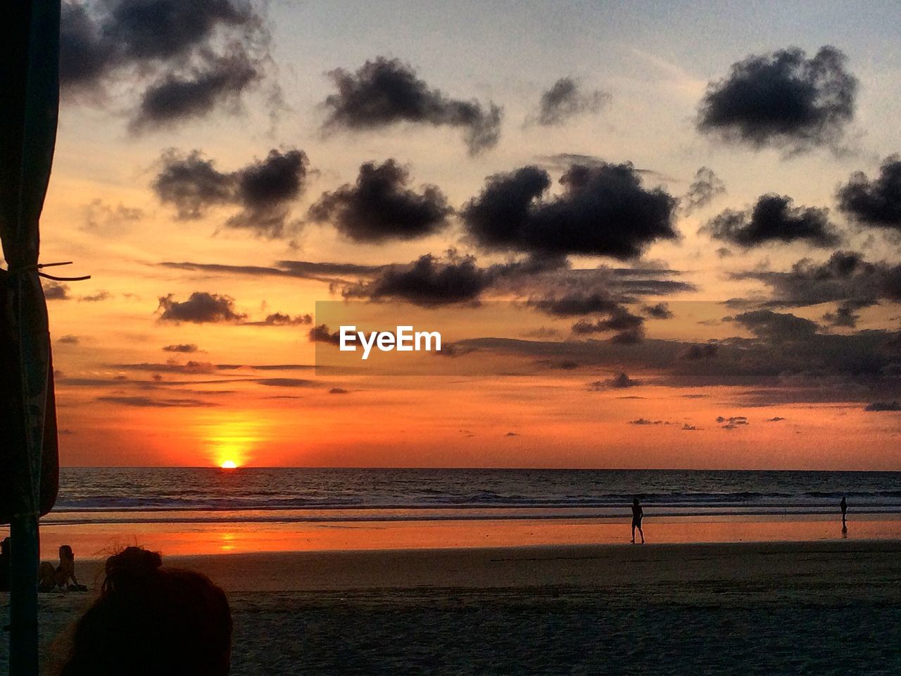 SCENIC VIEW OF BEACH AGAINST SKY AT SUNSET