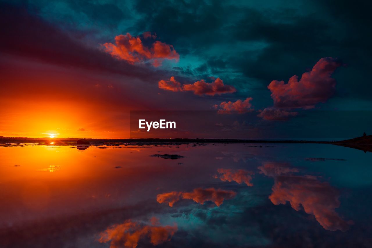 Scenic view of sea against romantic sky at sunset