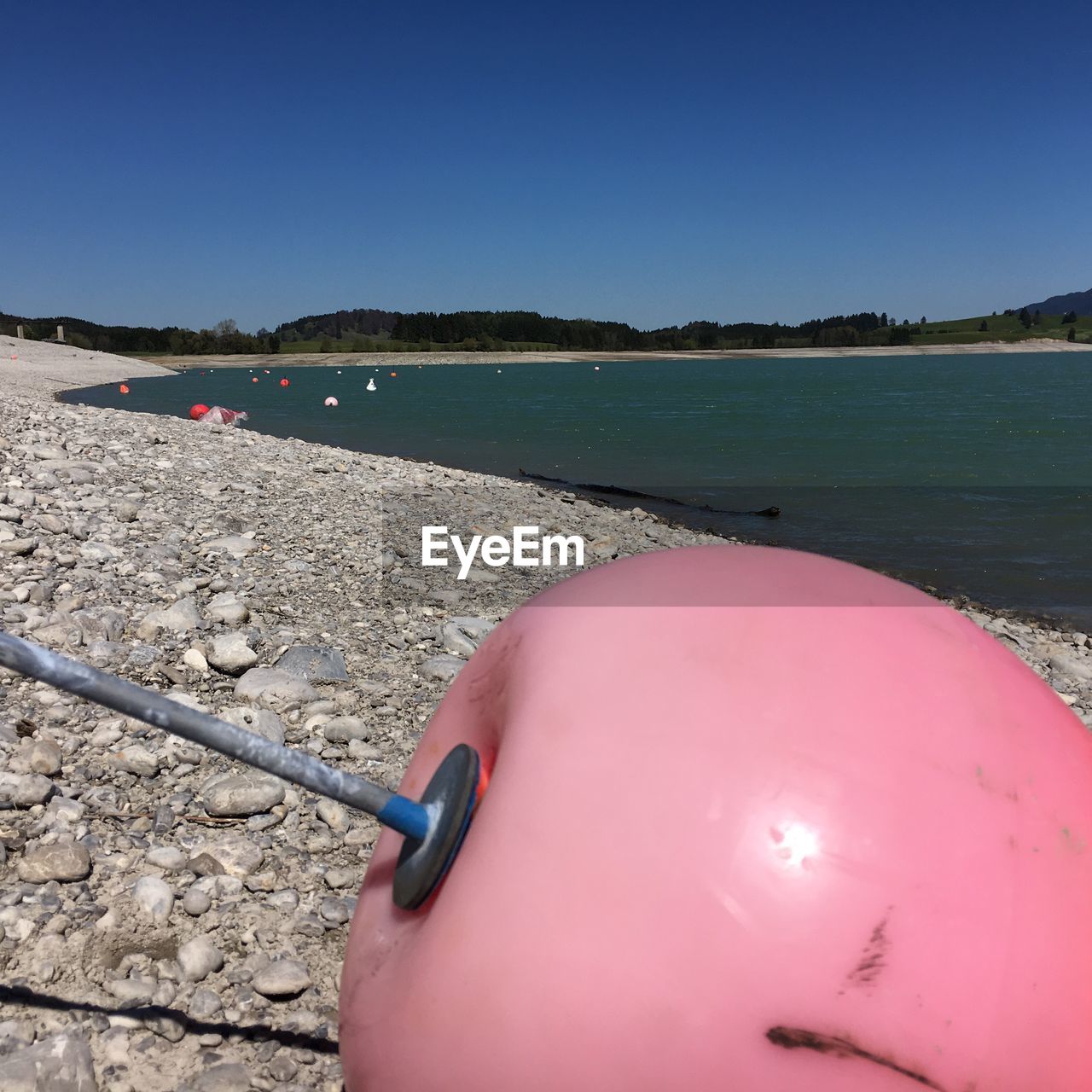 VIEW OF BEACH AGAINST CLEAR BLUE SKY