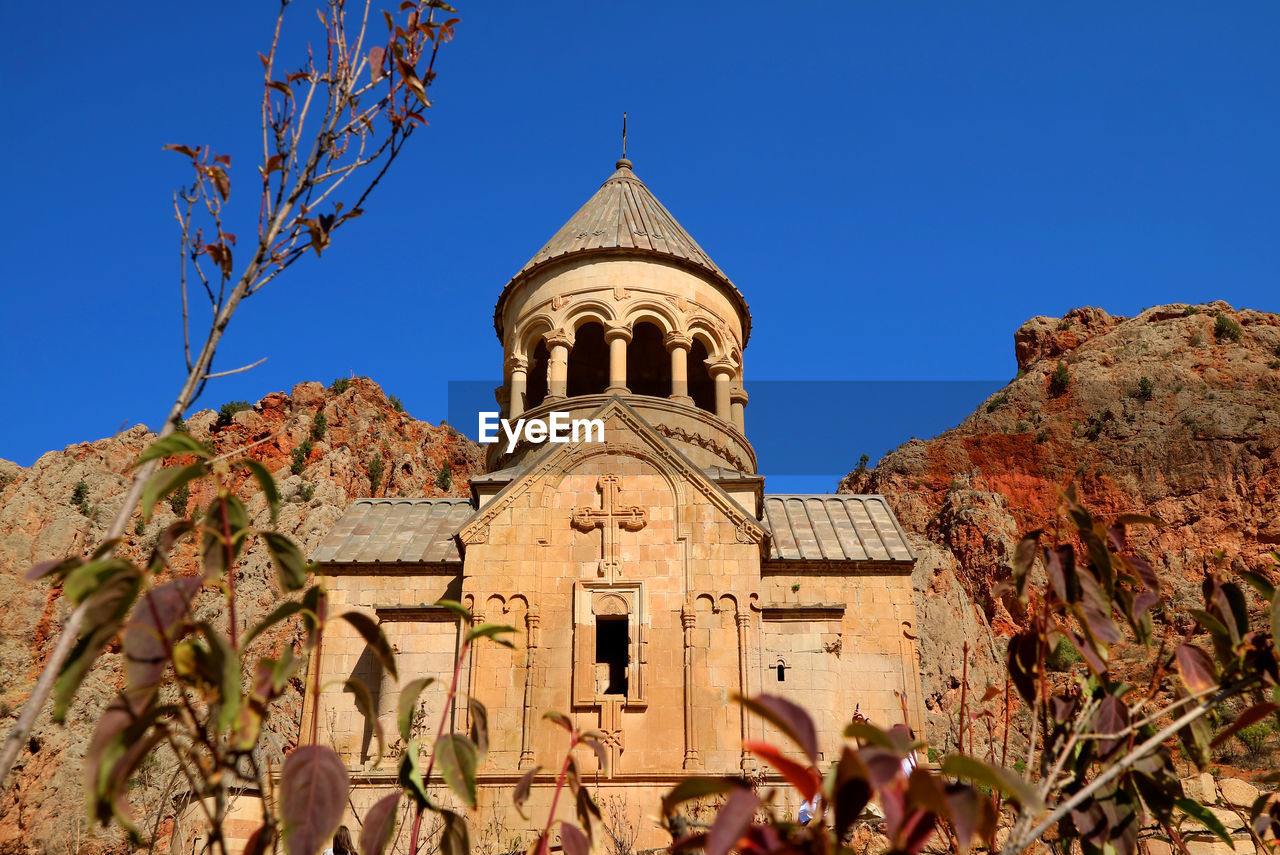 Surb astvatsatsin in noravank monastery among the fall foliage of vayots dzor province, armenia