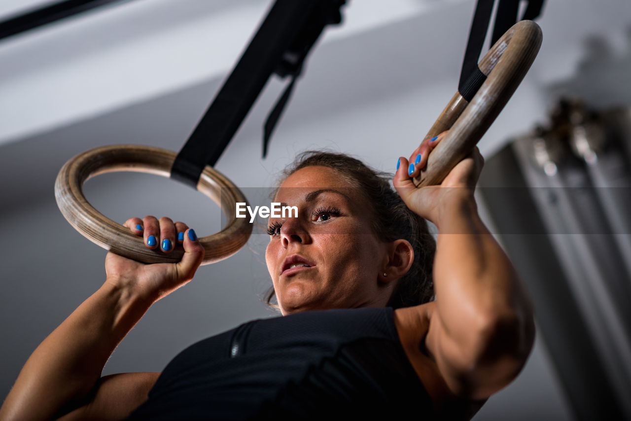 Low angle view of athlete exercising in gym