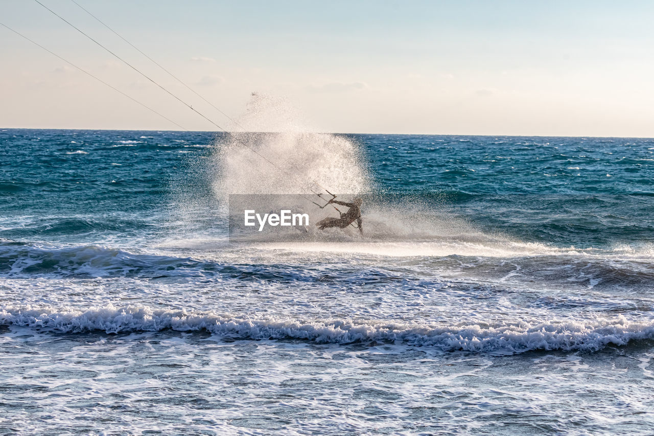 Water splashing in sea against sky