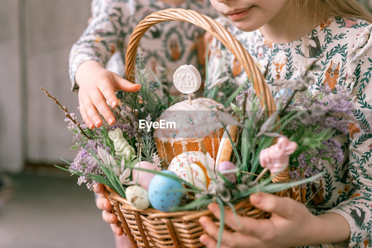 Happy easter holiday time spring season. family little kids holds basket painted eggs baked cakes