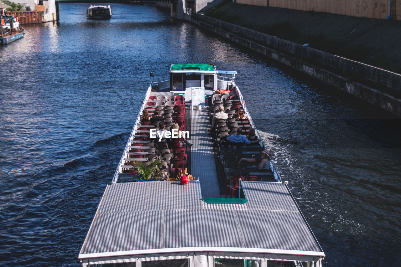 High angle view of people in ferryboat at lake