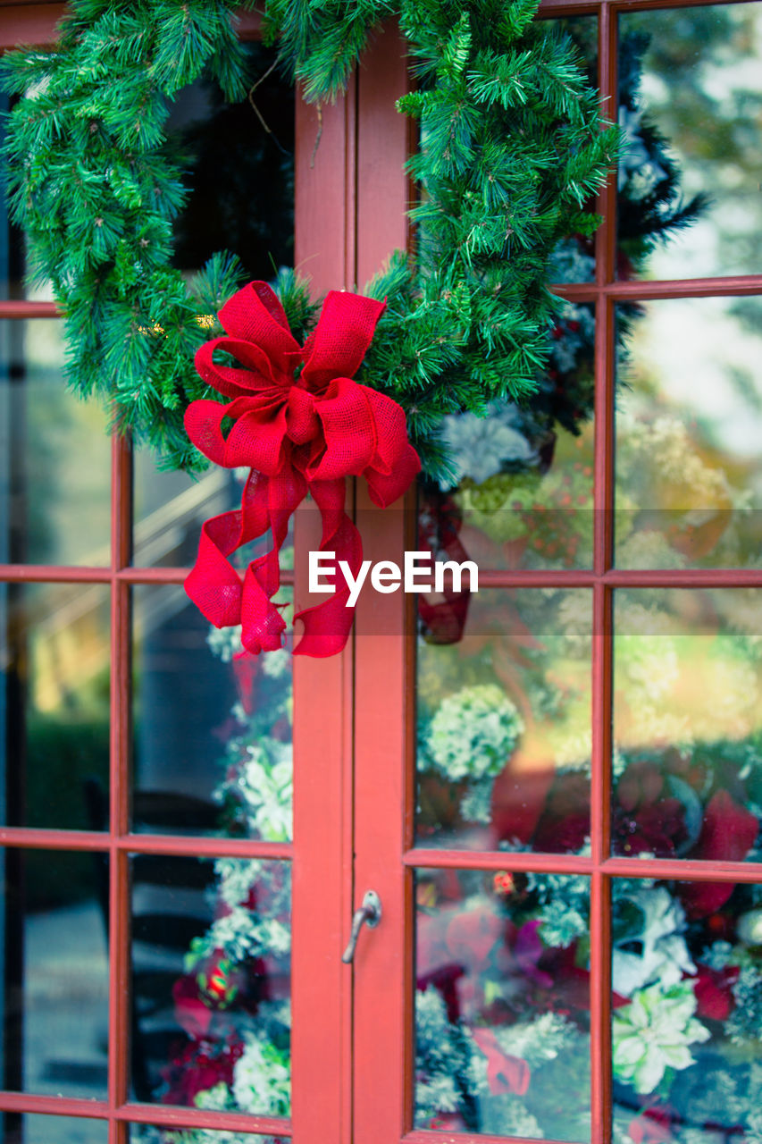 Wreath hanging on window during christmas